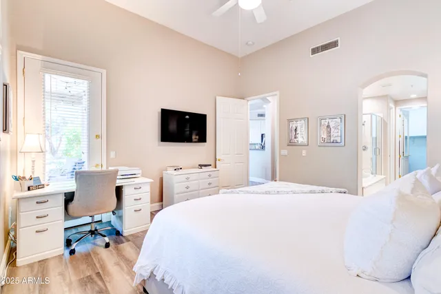 a bedroom with a bed and a flat screen tv