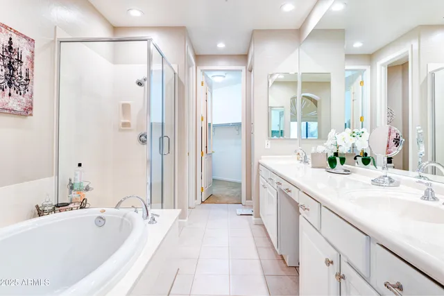 a spacious bathroom with a granite countertop tub sink a shower and a mirror