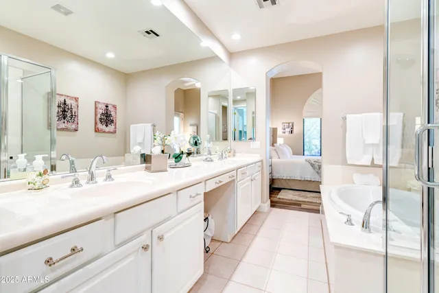 a spacious bathroom with a double vanity sink mirror and