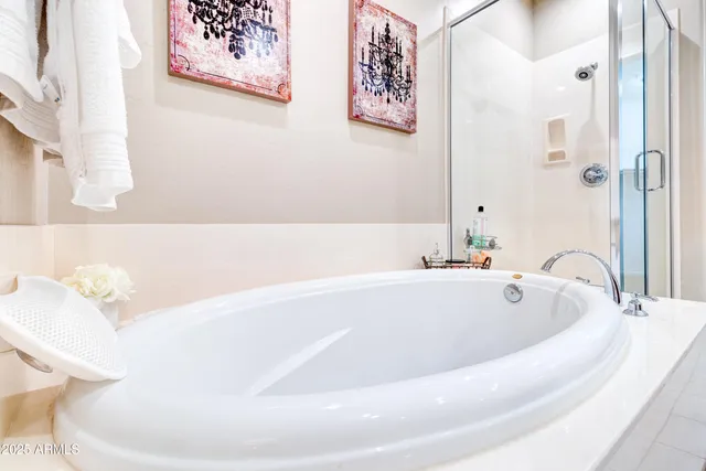 a bath tub sitting next to a white toilet
