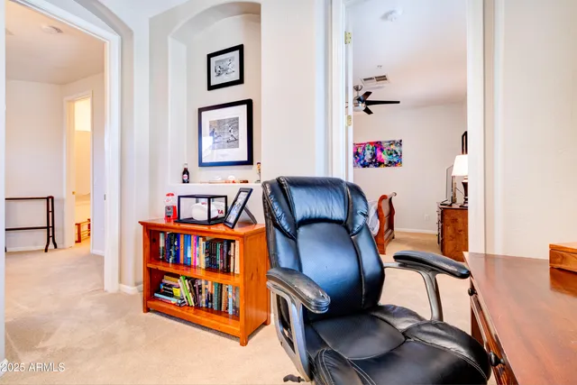 a living room with furniture and baby crib