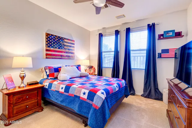 a bedroom with a bed and a dresser in it