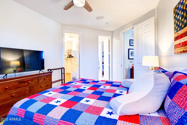 a bedroom with a bed and a flat screen tv