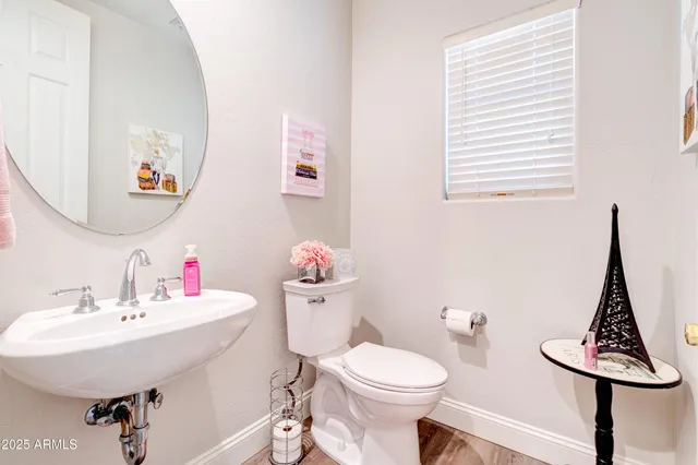a bathroom with a sink mirror and toilet