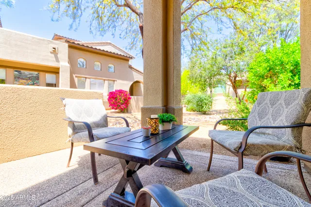 a view of a patio with couple of chairs and a table