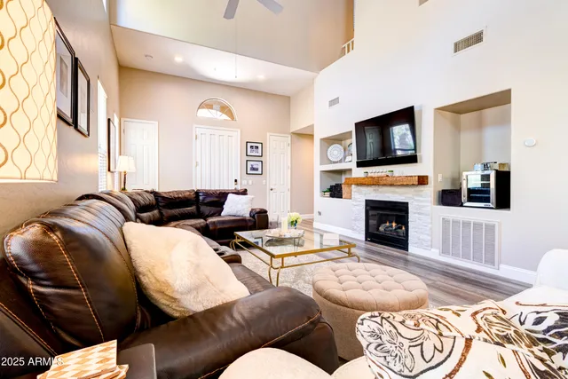 a living room with furniture fireplace and flat screen tv