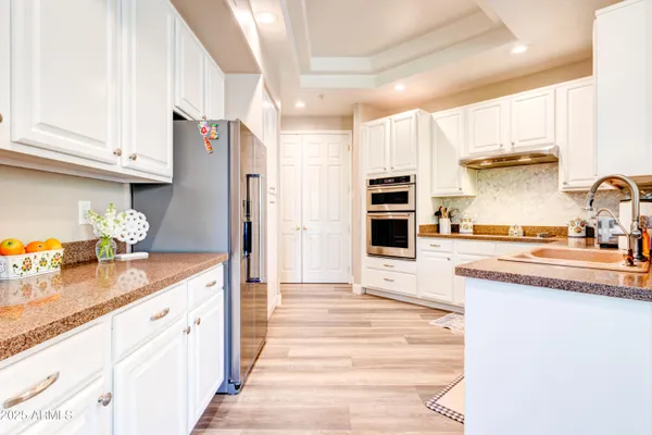 a kitchen with granite countertop a stove and a sink