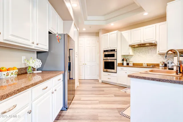 a kitchen with granite countertop a stove and a sink