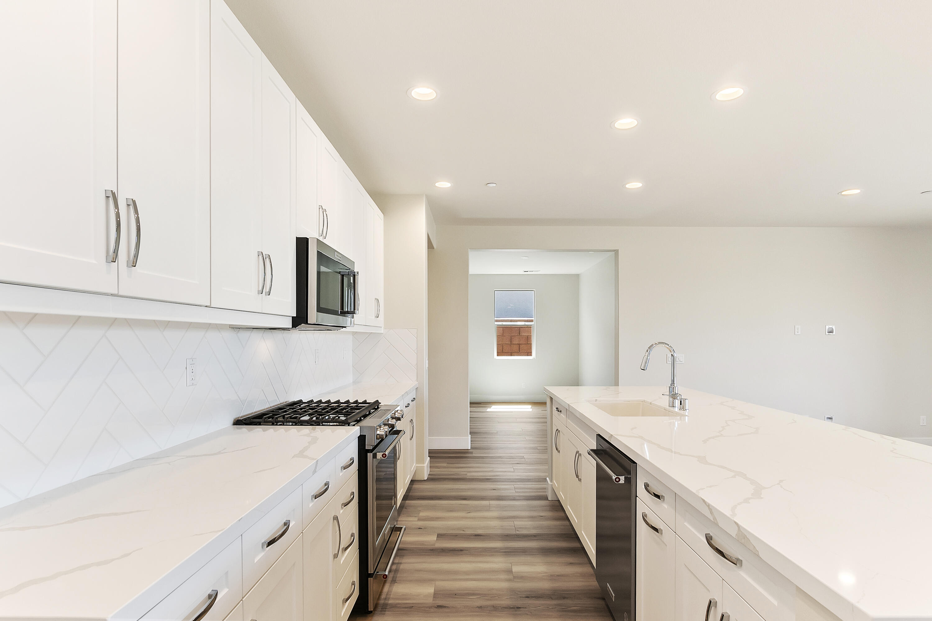 82365 Murray Canyon Drive, Unit LT#8199 Indio, CA 92201 - Photo 11 of 39 a large kitchen with stainless steel appliances granite countertop a lot of counter space and wooden floor