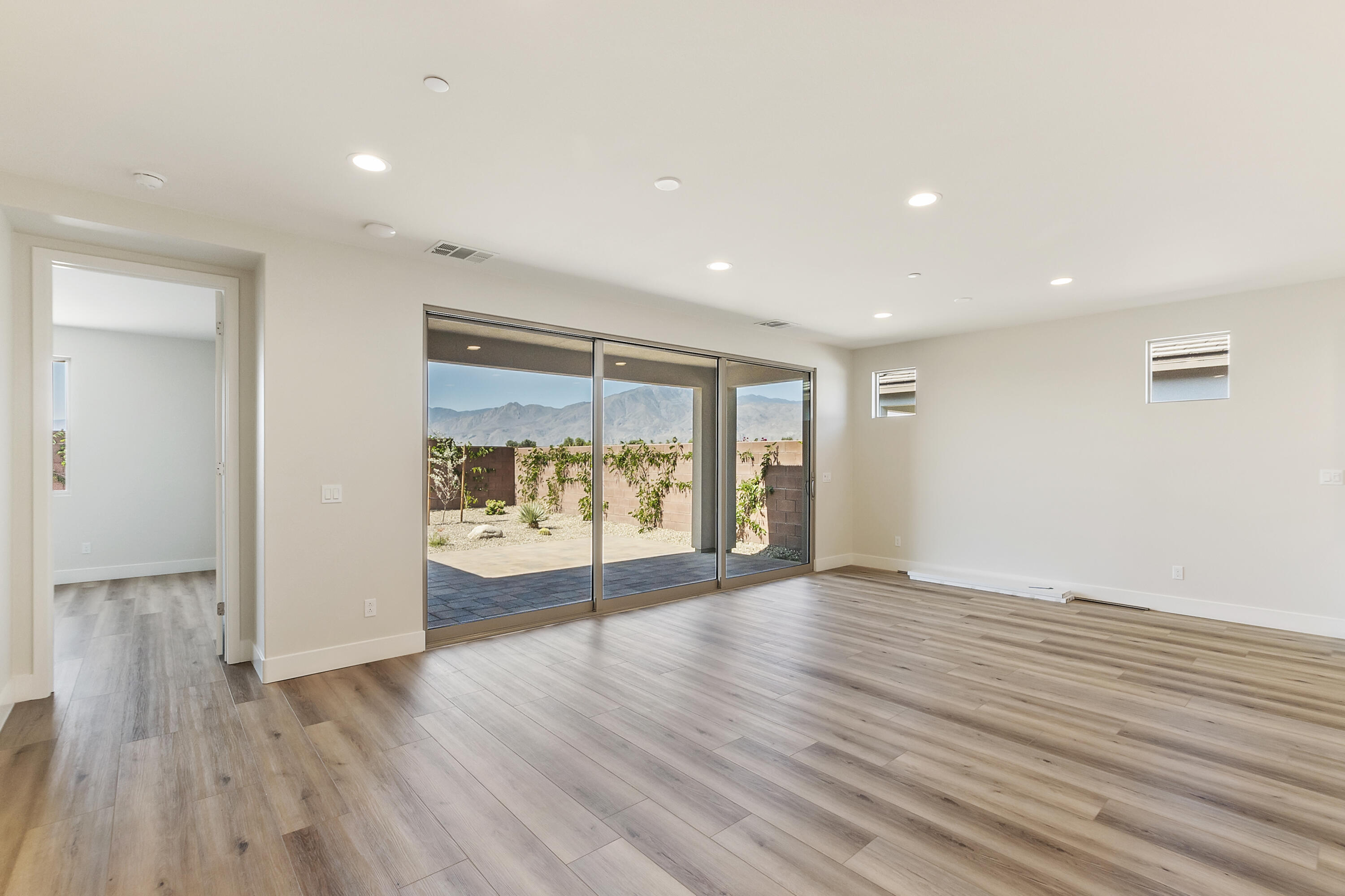 82365 Murray Canyon Drive, Unit LT#8199 Indio, CA 92201 - Photo 16 of 39 wooden floor in an empty room with a window