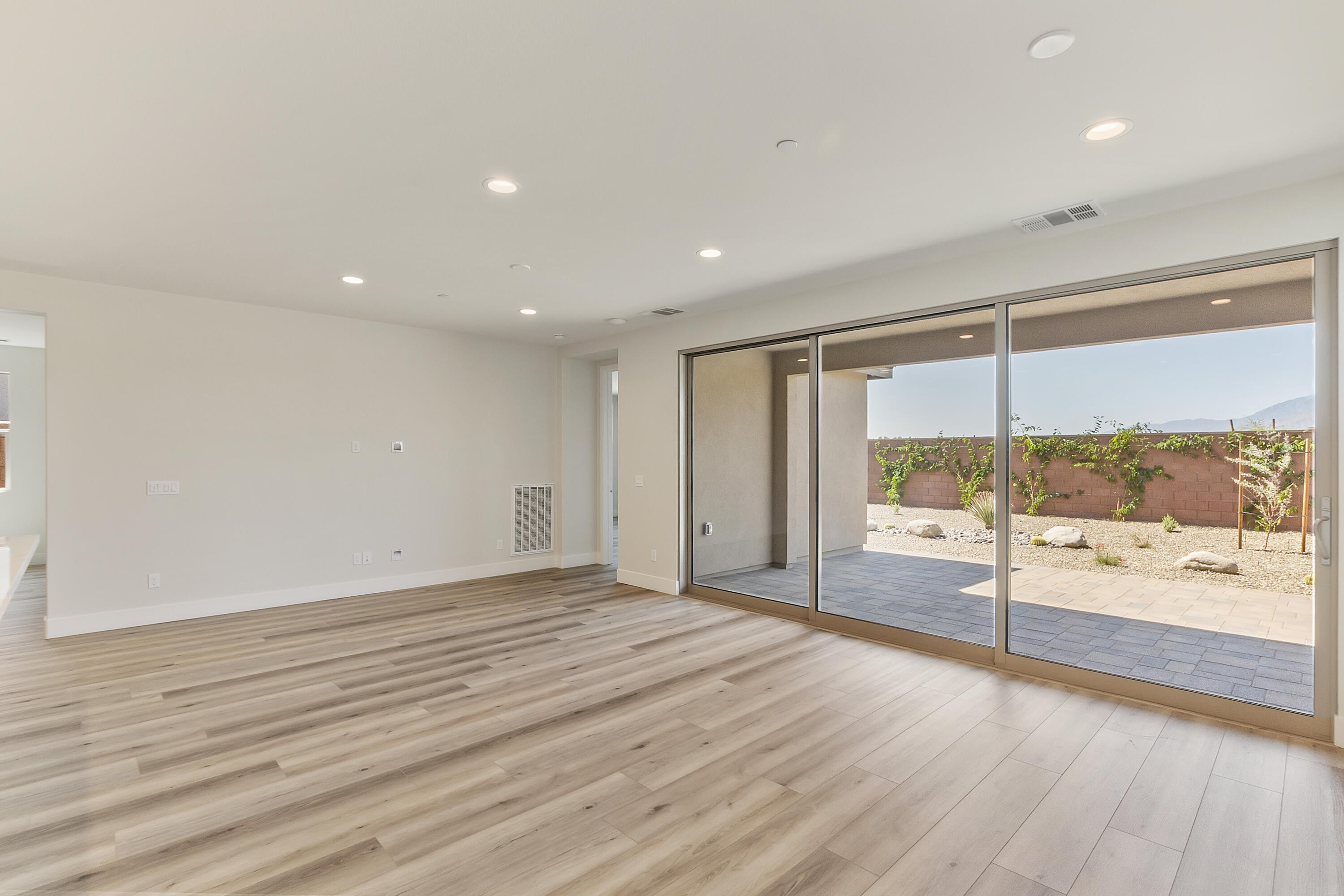 82365 Murray Canyon Drive, Unit LT#8199 Indio, CA 92201 - Photo 17 of 39 a view of a room with a floor to ceiling window and wooden floor
