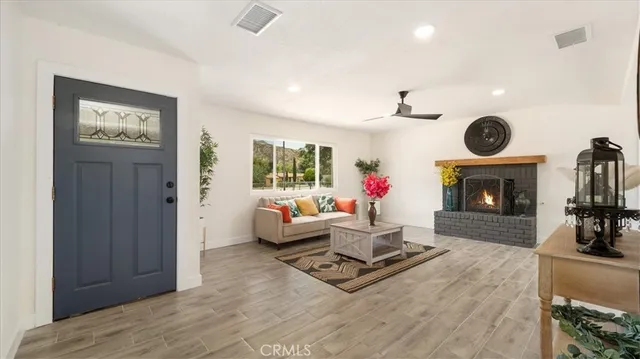 a living room with furniture a window and a clock