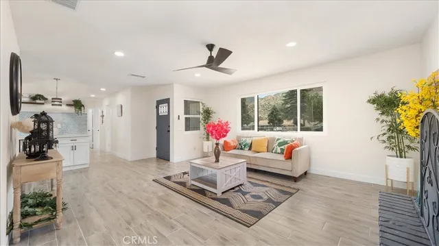 a living room with furniture and kitchen view