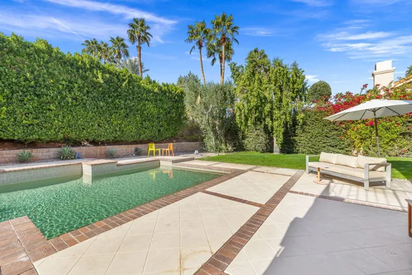 a living room with furniture a potted plant and a fireplace