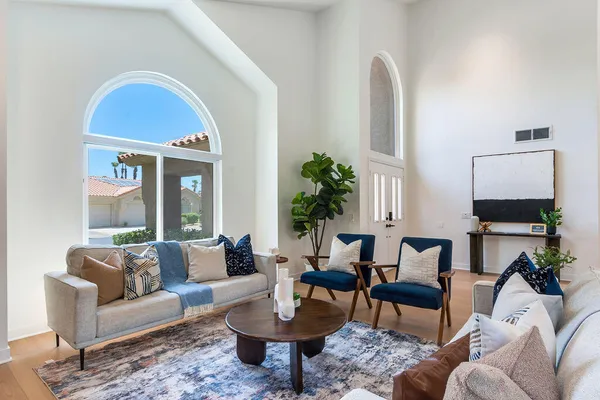 a dining room with wooden floor a glass table and chairs
