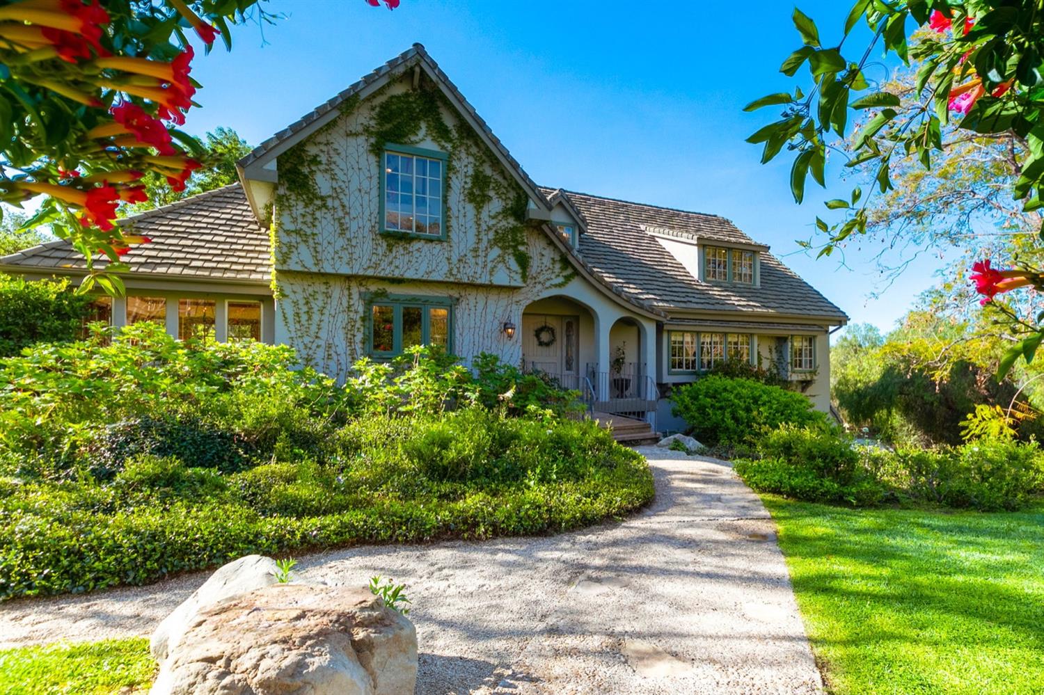 a front view of a house with a garden