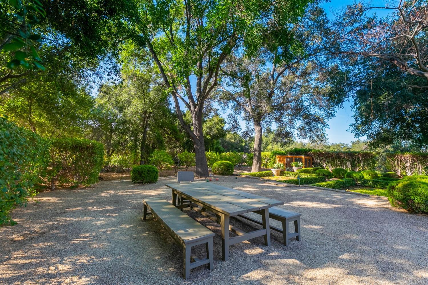 1712 Ladera Road Ojai, CA 93023 - Photo 41 of 47 a view of a patio with table and chairs and couches with large trees