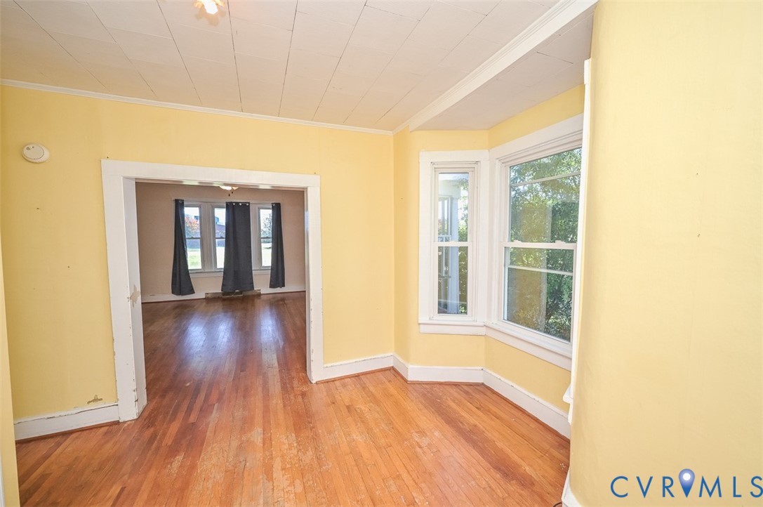 17519 New Baltimore Road Milford, VA 22514 - Photo 13 of 38 a view of an empty room with wooden floor and a window
