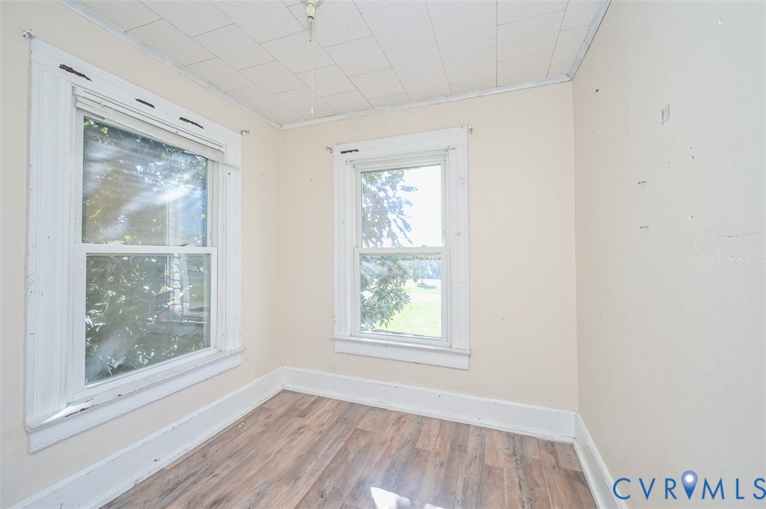 17519 New Baltimore Road Milford, VA 22514 - Photo 17 of 38 a view of an empty room with wooden floor and a window