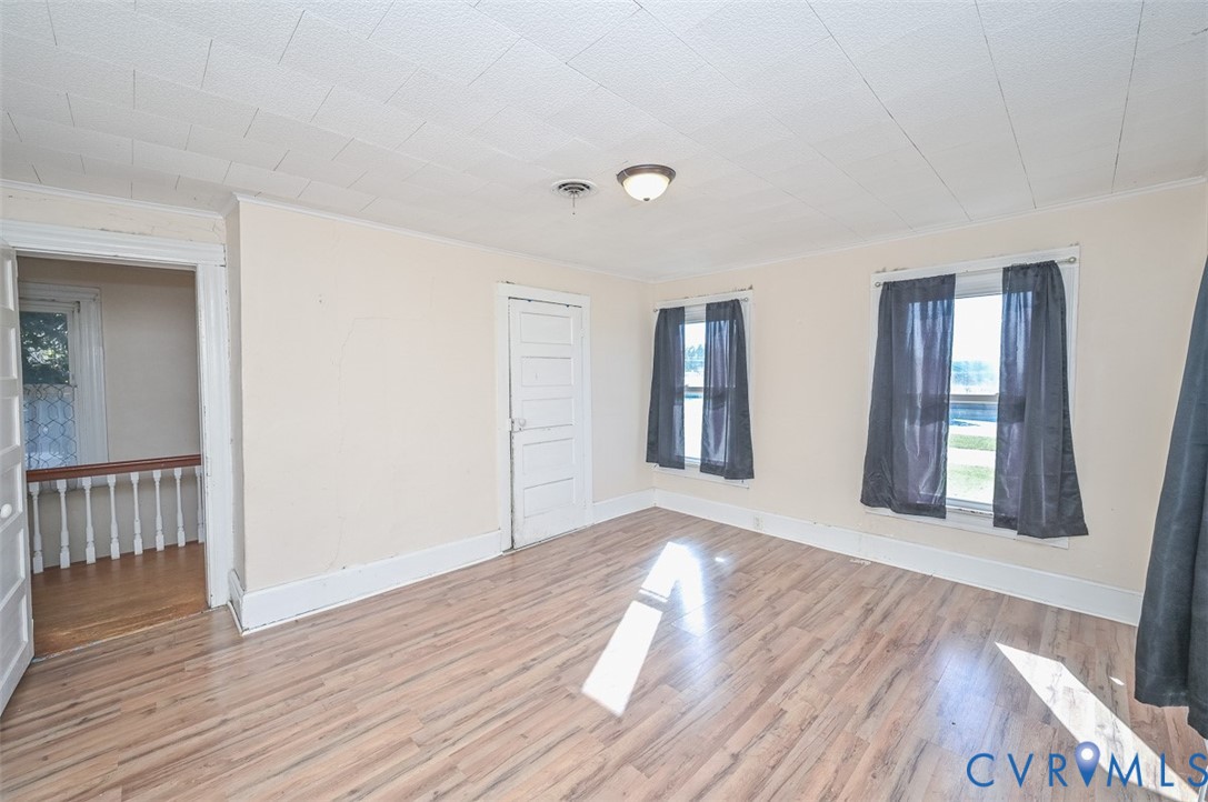 17519 New Baltimore Road Milford, VA 22514 - Photo 25 of 38 a view of an empty room with wooden floor and a window