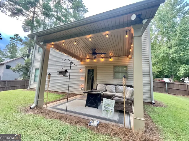 a backyard of a house with table and chairs
