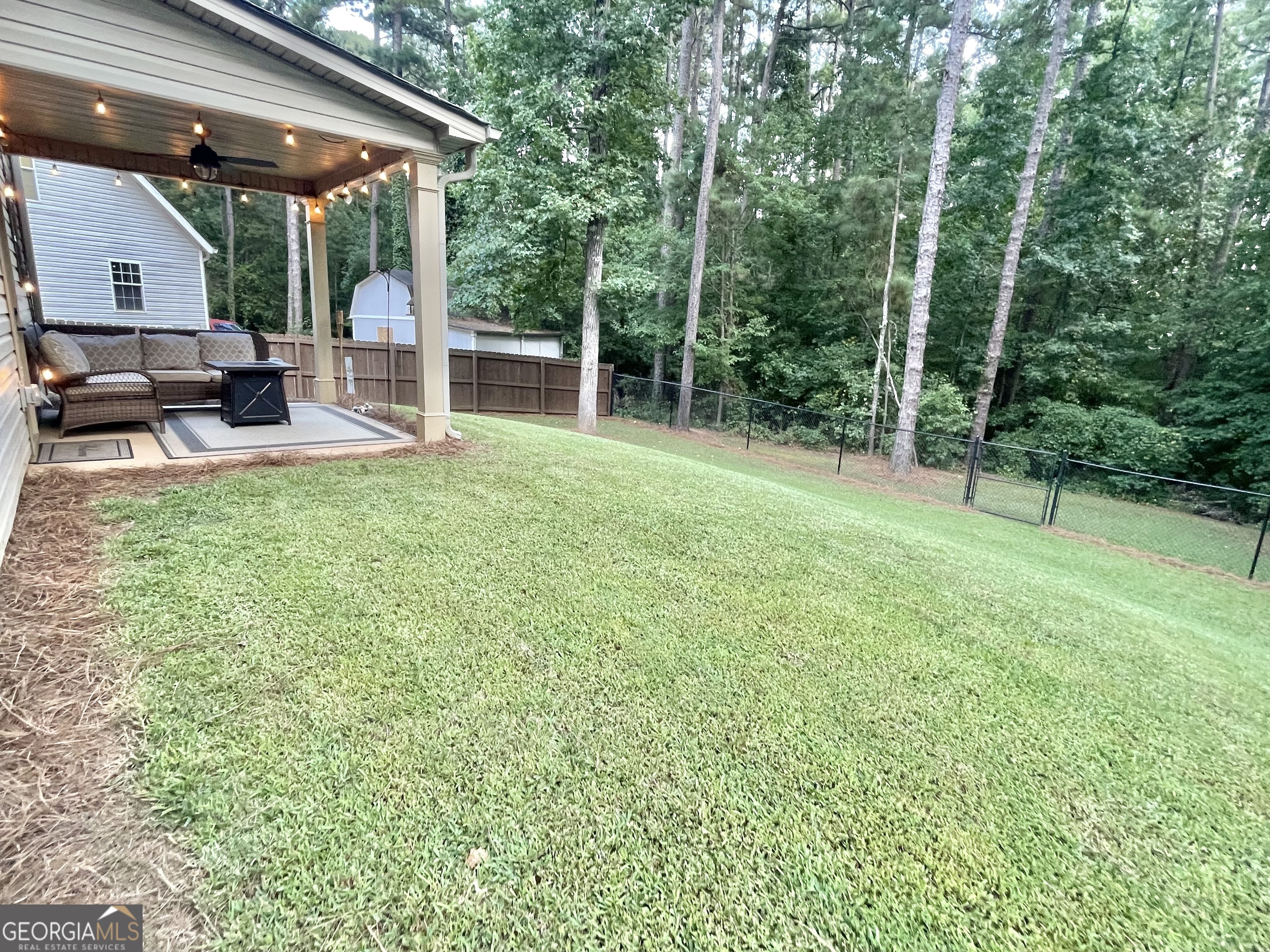 57 Partridge Court Monticello, GA 31064 - Photo 19 of 57 a view of backyard with a table and chairs and potted plants