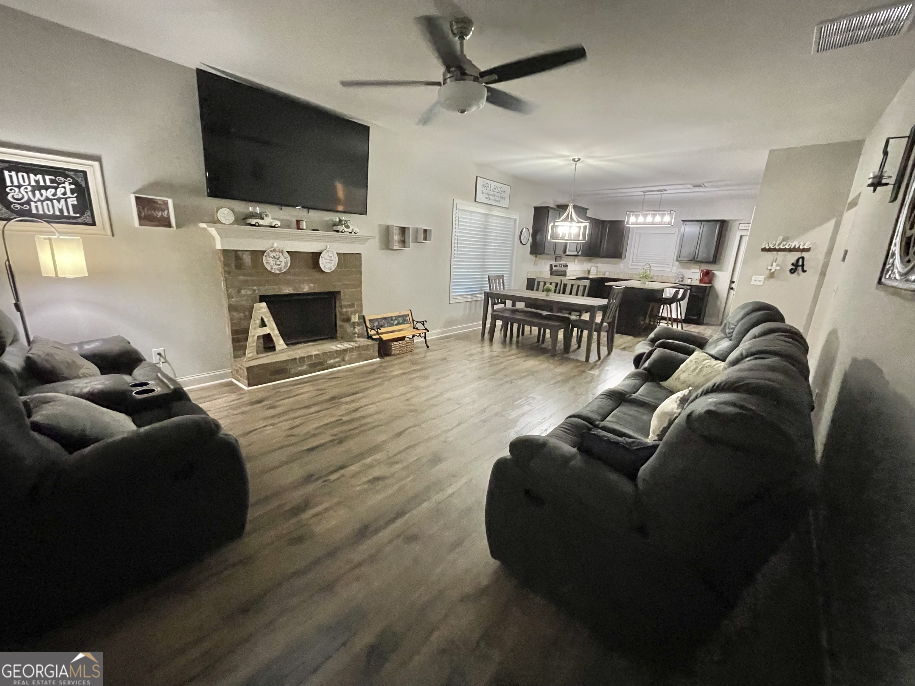 57 Partridge Court Monticello, GA 31064 - Photo 20 of 57 a living room with furniture a flat screen tv and a fireplace