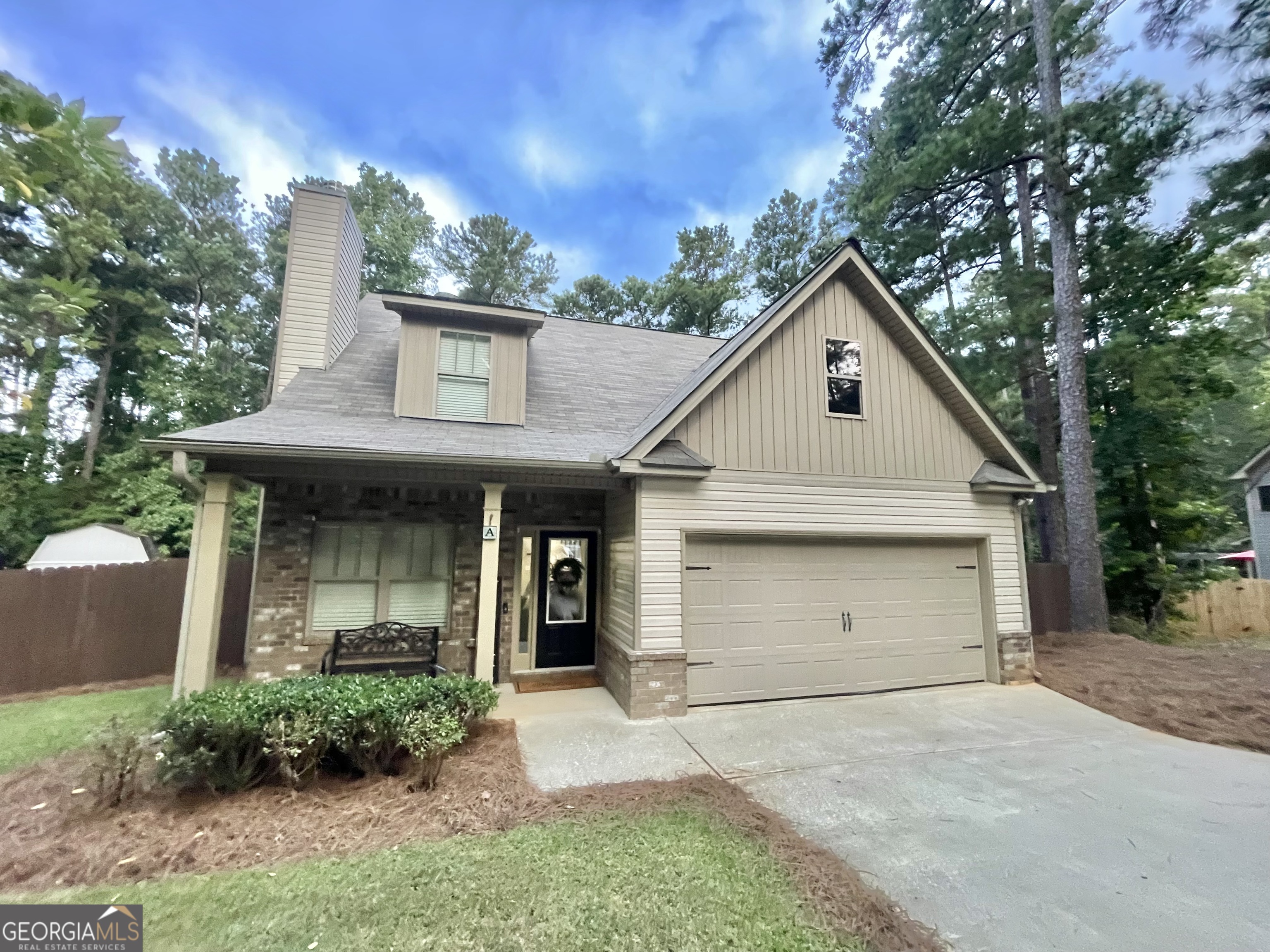 57 Partridge Court Monticello, GA 31064 - Photo 2 of 57 a view of a white house with large windows and a small yard