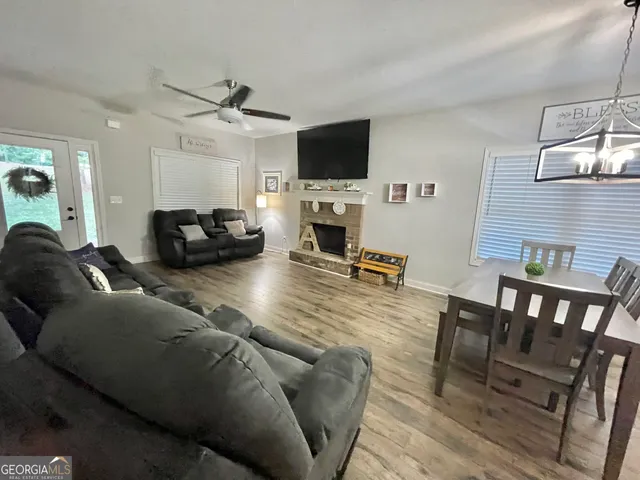 a kitchen with stainless steel appliances granite countertop wooden cabinets refrigerator and microwave
