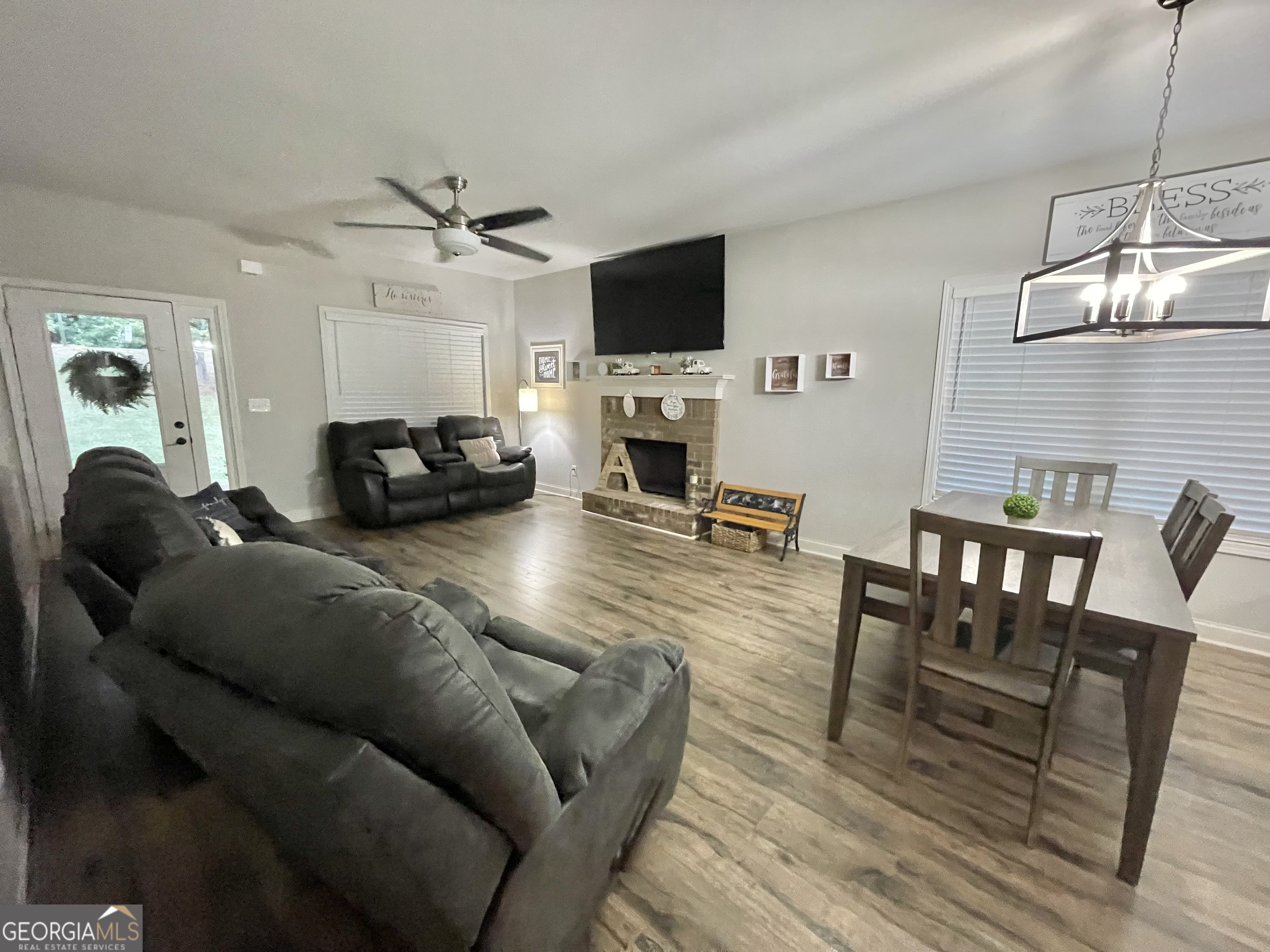 57 Partridge Court Monticello, GA 31064 - Photo 24 of 57 a living room with furniture a flat screen tv and kitchen view