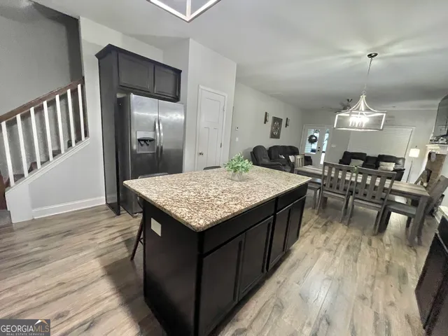 a spacious bedroom with a bed and a chandelier