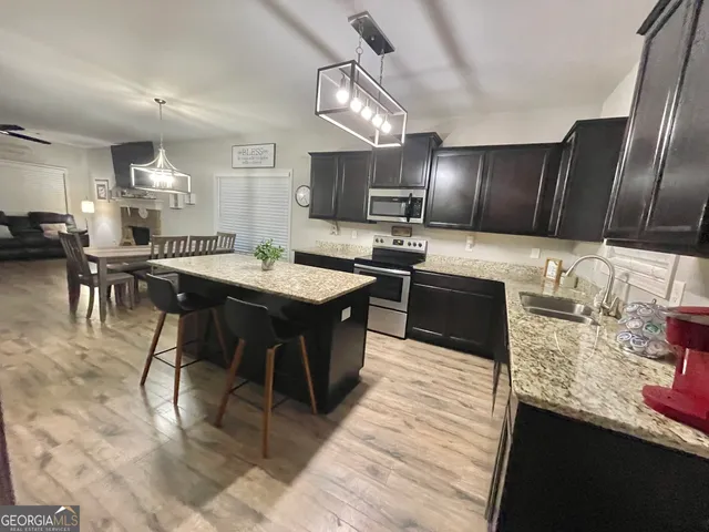 a spacious bedroom with a bed and a flat screen tv