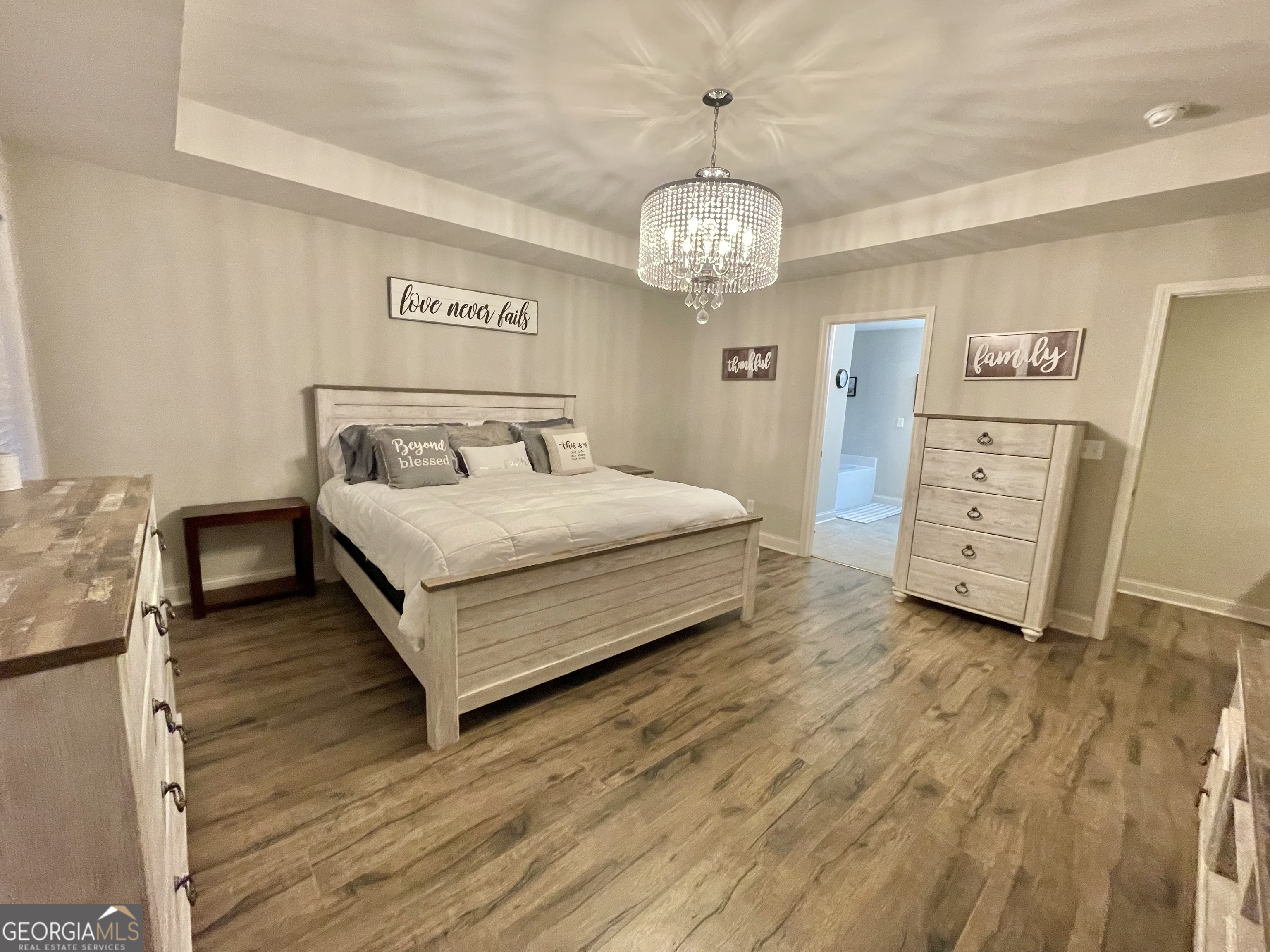 57 Partridge Court Monticello, GA 31064 - Photo 31 of 57 a spacious bedroom with a bed and a chandelier