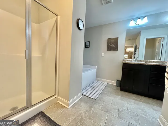 a bathroom with a tub sink and shower