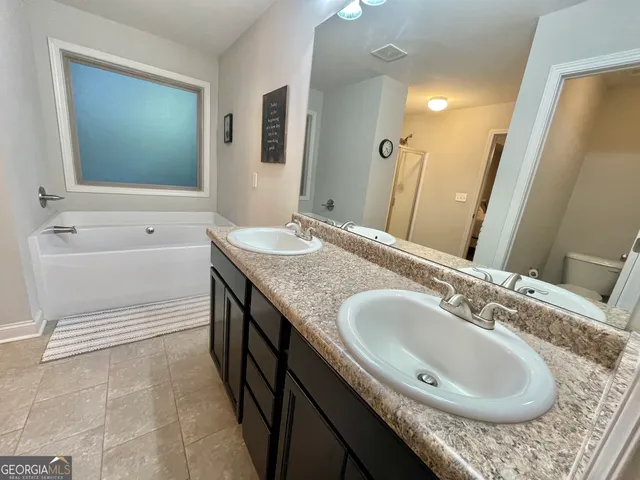 a bathroom with a tub and shower