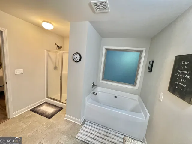 a bathroom with a glass shower door and a sink