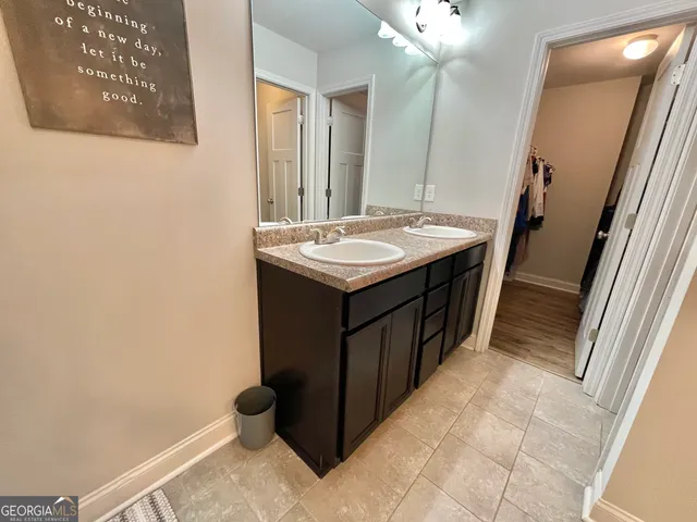 a view of a hallway with wooden floor and stairs