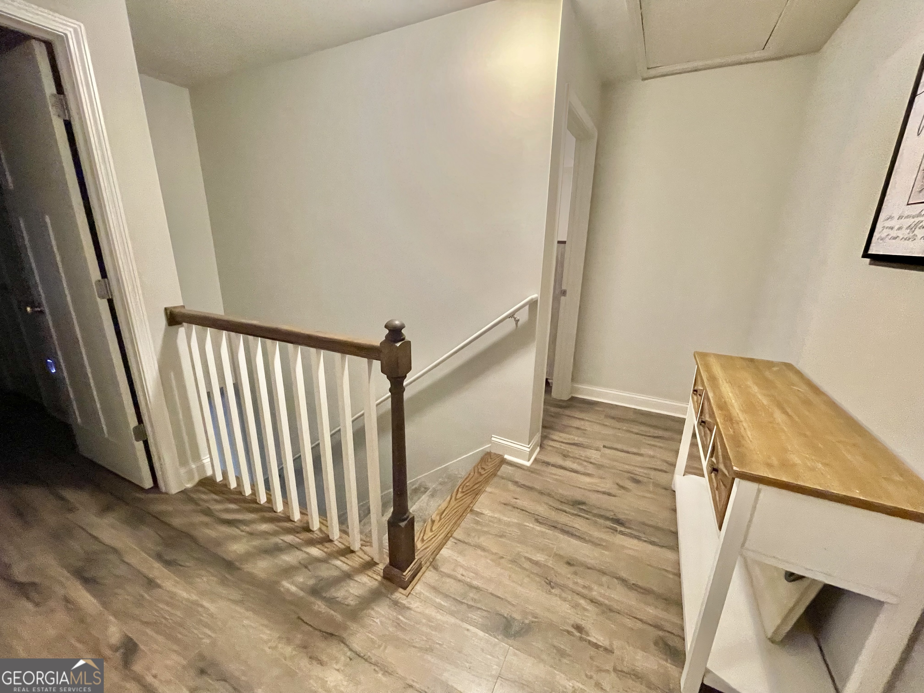 57 Partridge Court Monticello, GA 31064 - Photo 46 of 57 a view of a hallway with wooden floor and stairs