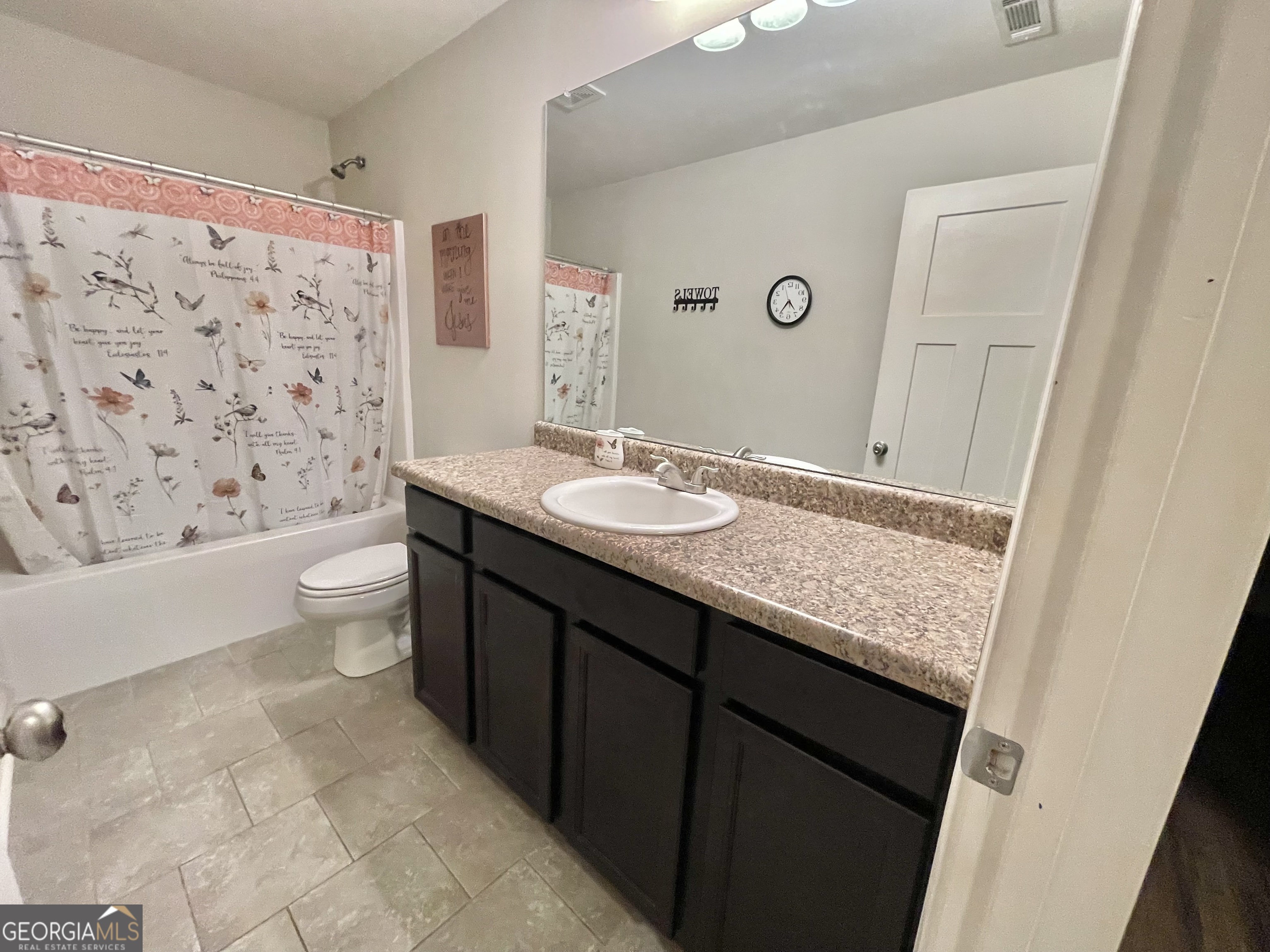 57 Partridge Court Monticello, GA 31064 - Photo 48 of 57 a bathroom with a granite countertop sink a toilet a mirror and shower curtain