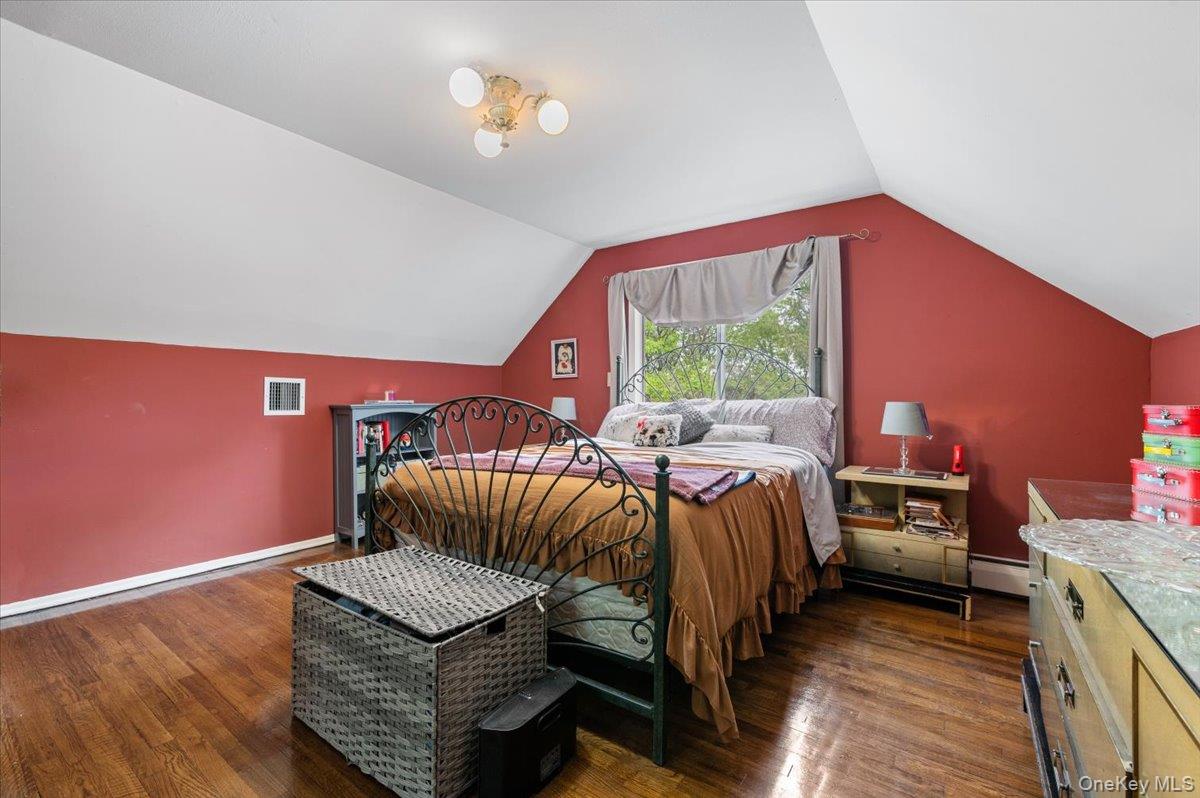 6 Apex Road Melville, NY 11747 - Photo 29 of 50 a bedroom with a bed and wooden floor