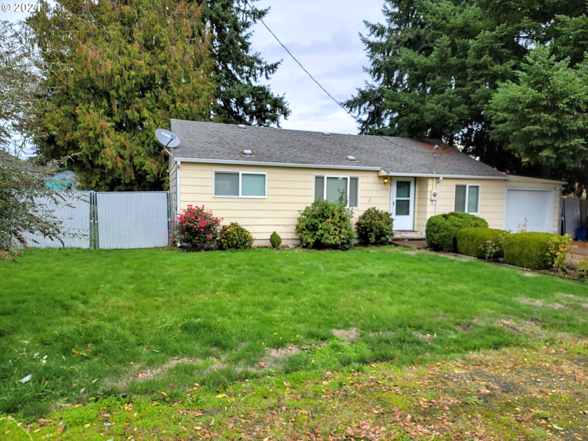 a front view of house with yard and green space