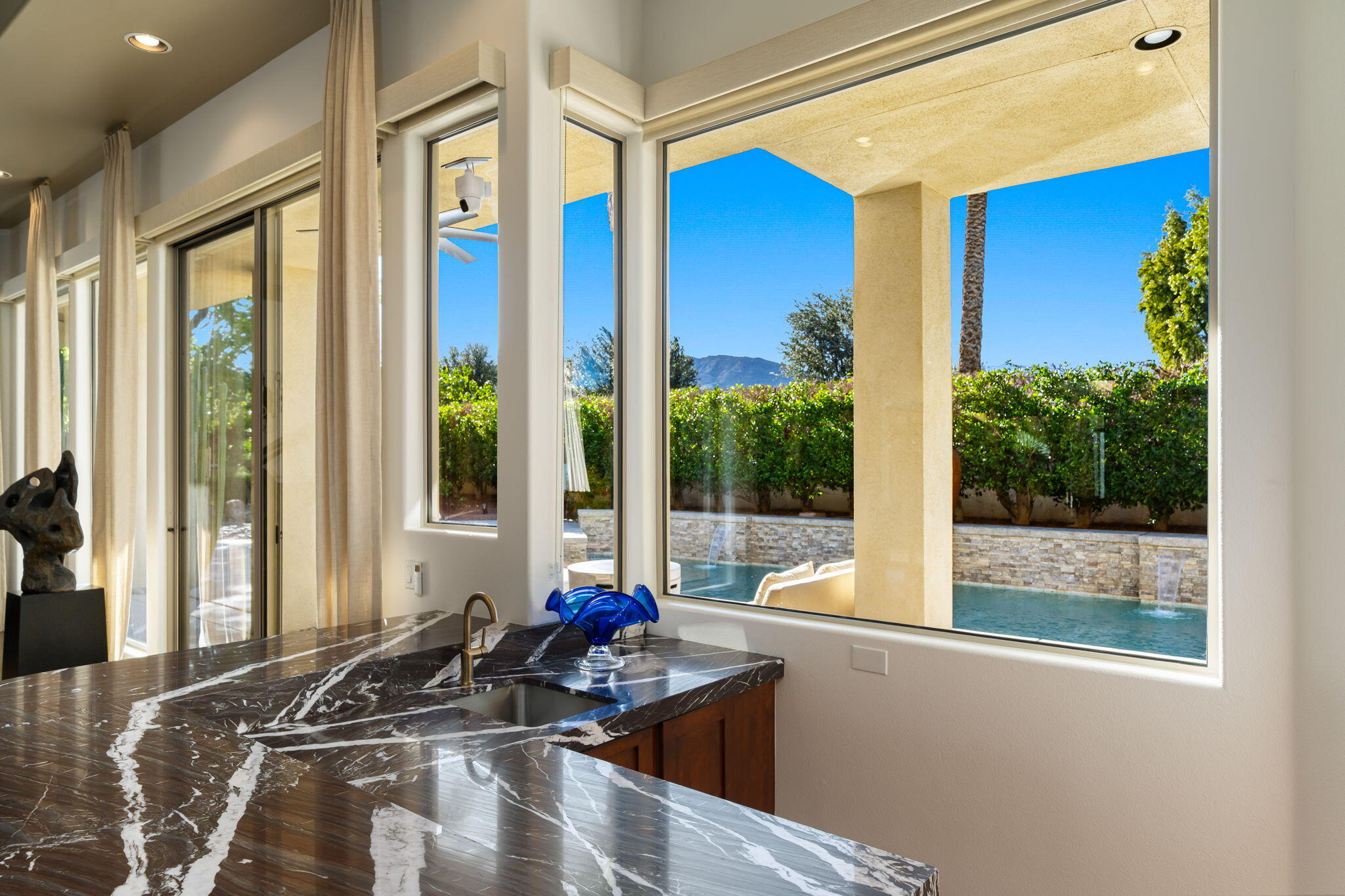 103 Waterford Circle Rancho Mirage, CA 92270 - Photo 13 of 44 a living room with furniture and floor to ceiling windows