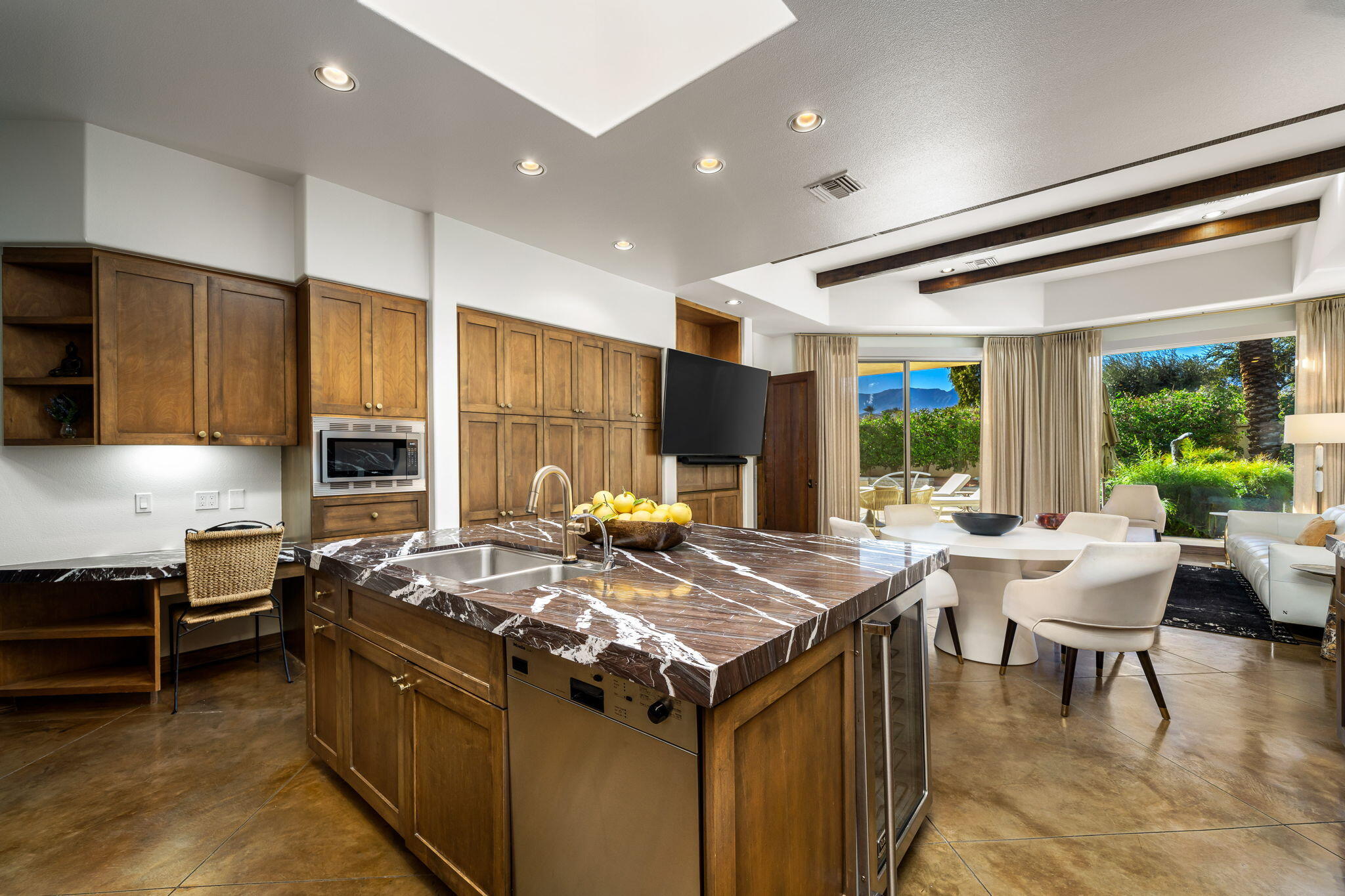 103 Waterford Circle Rancho Mirage, CA 92270 - Photo 15 of 44 a view of a kitchen with kitchen island stainless steel appliances a table and chairs in it