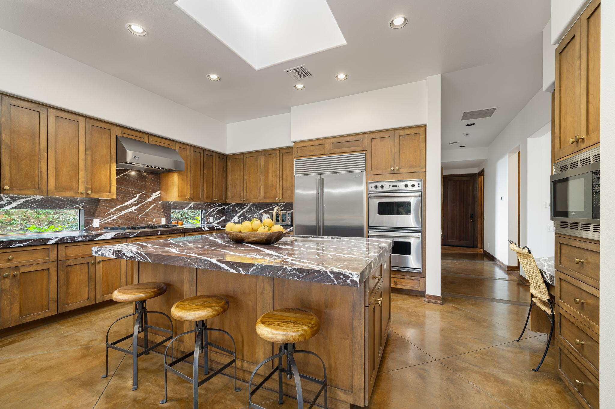 103 Waterford Circle Rancho Mirage, CA 92270 - Photo 18 of 44 a kitchen with stainless steel appliances a table and chairs in it