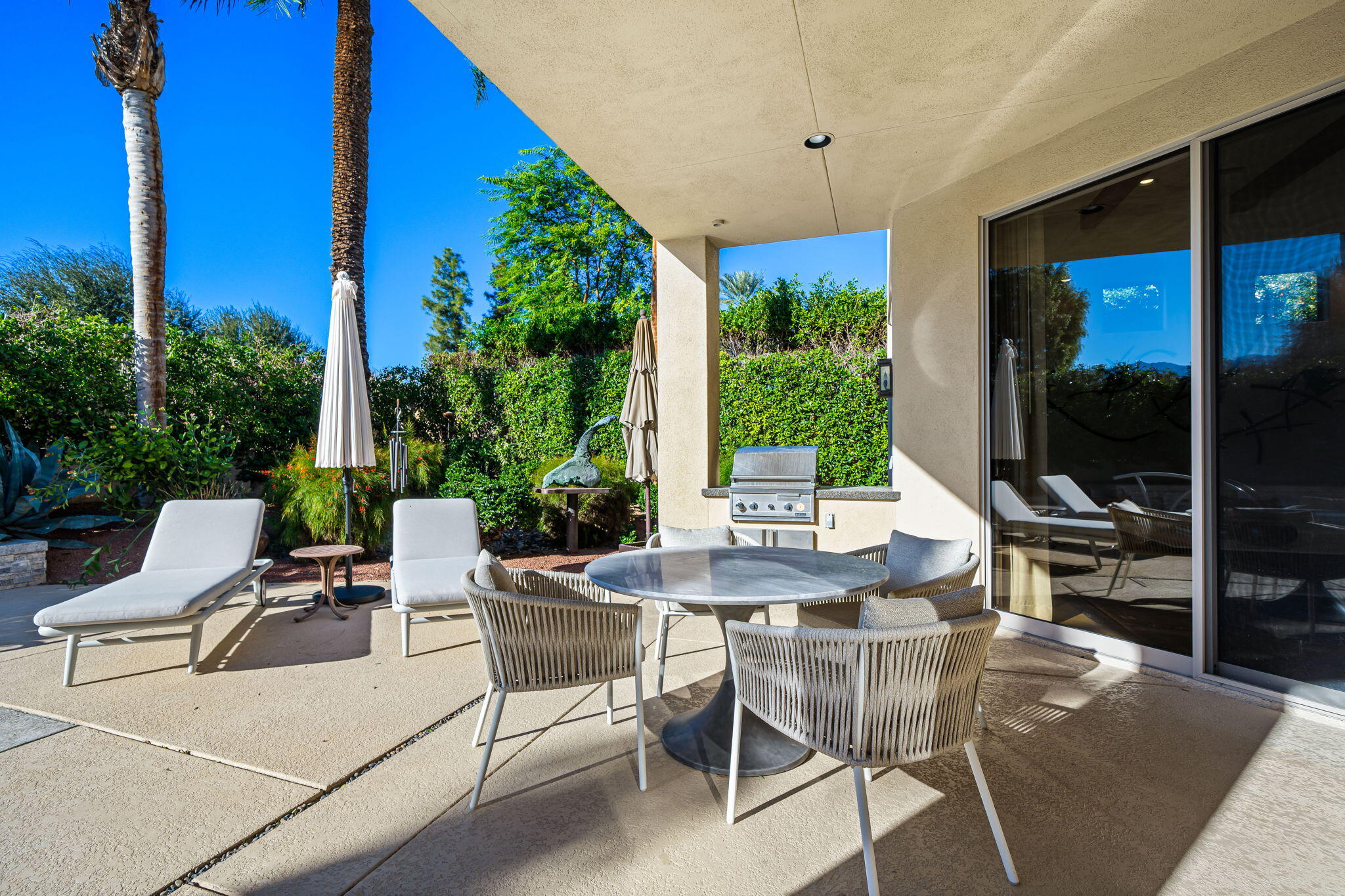 103 Waterford Circle Rancho Mirage, CA 92270 - Photo 25 of 44 a view of a patio with a table and chairs