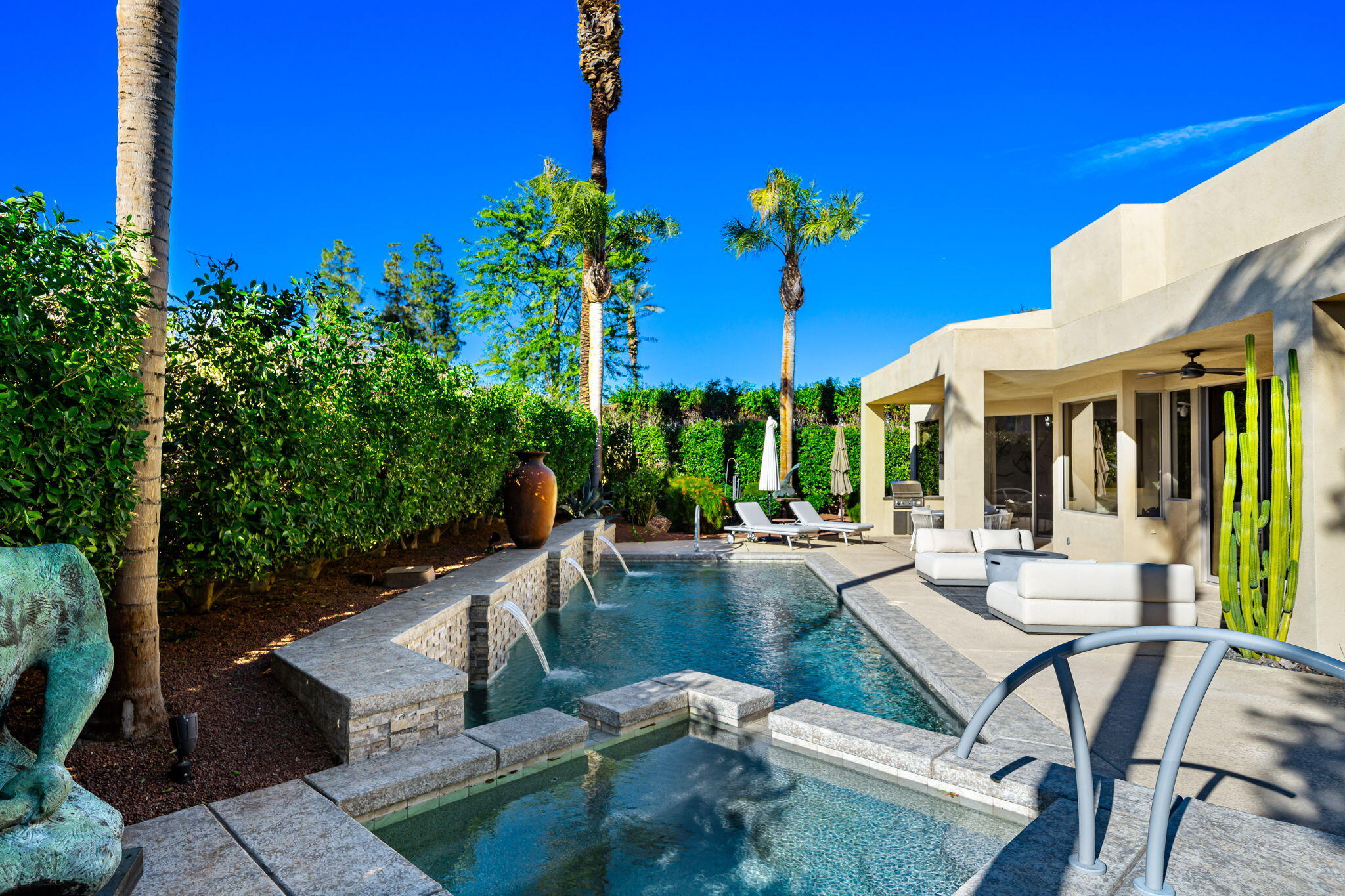 103 Waterford Circle Rancho Mirage, CA 92270 - Photo 28 of 44 a view of a patio with table and chairs and potted plants