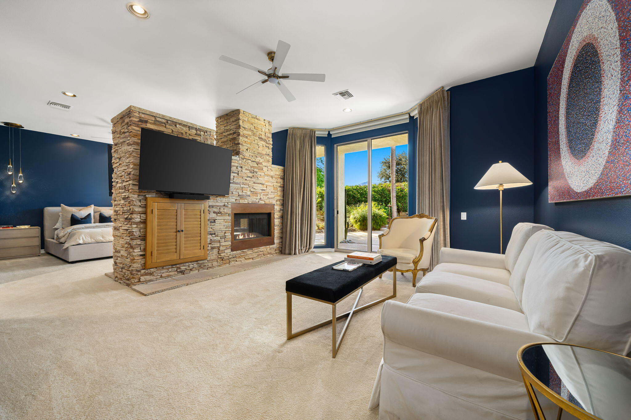 103 Waterford Circle Rancho Mirage, CA 92270 - Photo 30 of 44 a living room with furniture a fireplace and a flat screen tv