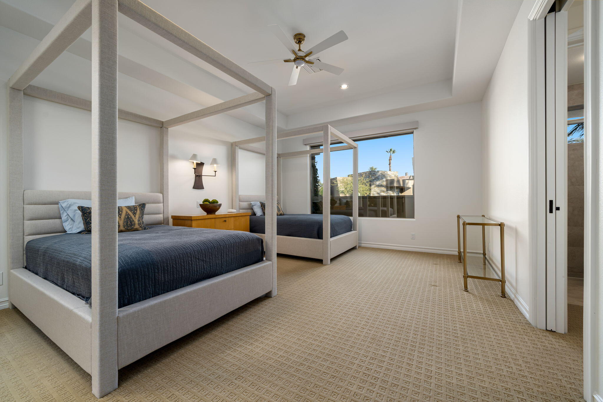 103 Waterford Circle Rancho Mirage, CA 92270 - Photo 38 of 44 a bedroom with a large bed and a chandelier