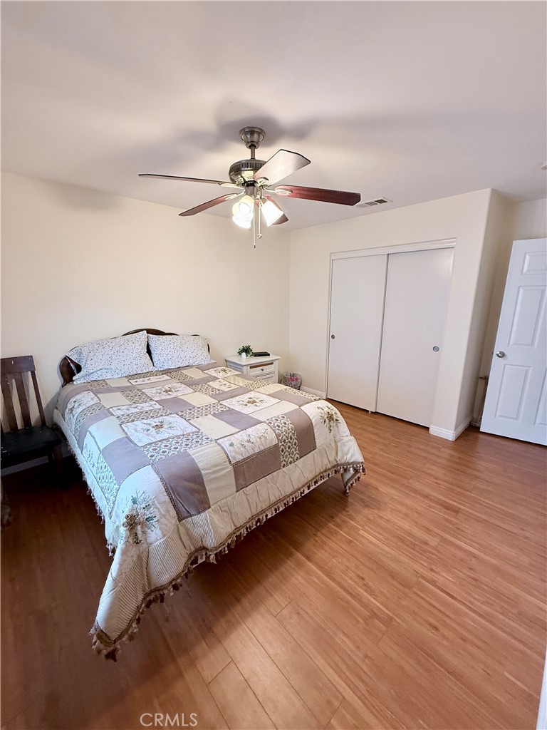 916 Roxanne Drive Hemet, CA 92543 - Photo 18 of 32 a bedroom with a bed and a ceiling fan