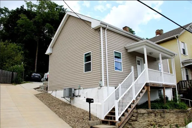 a view of a house with wooden fence